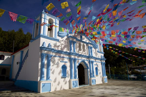 Festive holiday flags on Mexican church